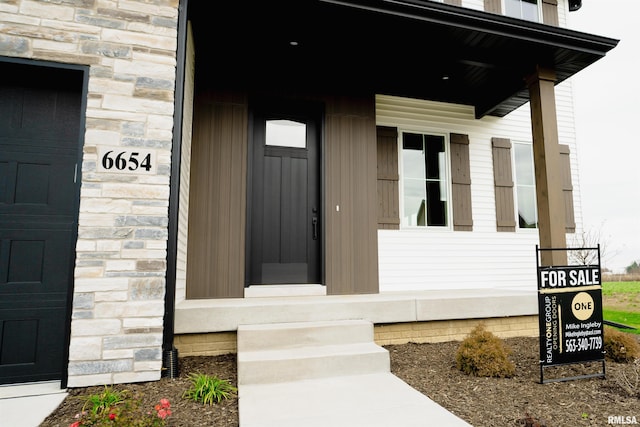 6654 Meghan Ave, Bettendorf, IA 52722 - view of exterior entry with stone siding and covered porch