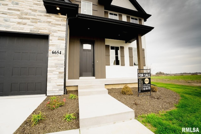 6654 Meghan Ave, Bettendorf, IA 52722 - property entrance with stone siding and covered porch