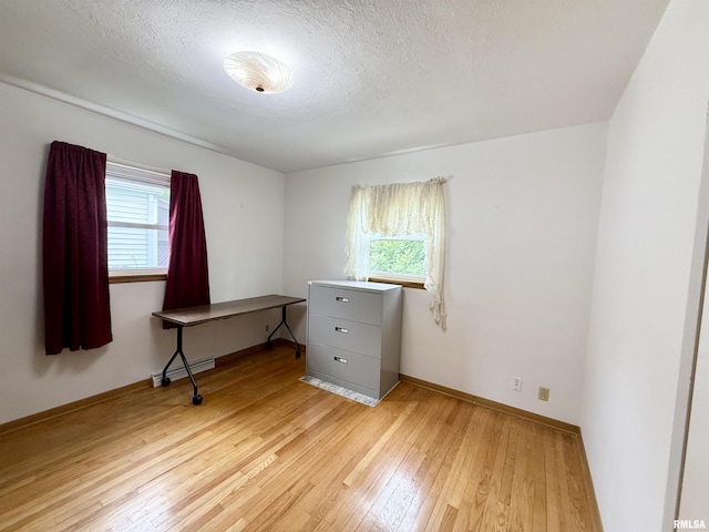 10 Blackhawk Hills Ct, Rock Island, IL 61201 - spare room featuring light wood-style floors, baseboards, and a textured ceiling