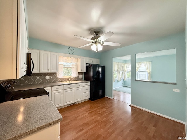 10 Blackhawk Hills Ct, Rock Island, IL 61201 - kitchen featuring black appliances, a sink, a ceiling fan, backsplash, and white cabinets