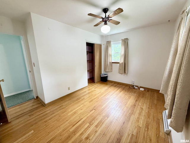 10 Blackhawk Hills Ct, Rock Island, IL 61201 - unfurnished bedroom featuring light wood-style floors, a closet, baseboards, and ceiling fan