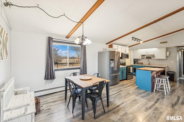 944 45th St, New Boston, IL 61272 - dining room featuring baseboard heating, a chandelier, light wood-type flooring, and vaulted ceiling