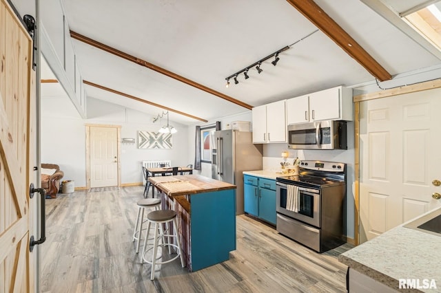 944 45th St, New Boston, IL 61272 - kitchen with appliances with stainless steel finishes, wood counters, a breakfast bar, and light wood-type flooring
