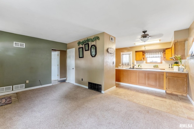 2215 N Nevada Ave, Davenport, IA 52804 - kitchen with light colored carpet, decorative backsplash, and light countertops