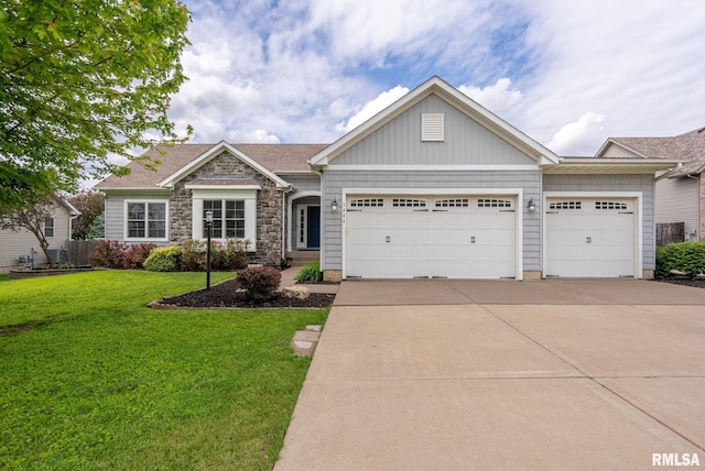 3484 Field Sike Dr, Bettendorf, IA 52722 - view of front of home with a garage, a front lawn, driveway, and stone siding