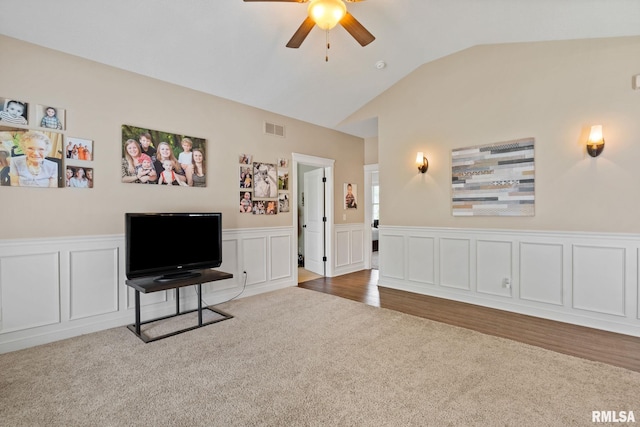 3484 Field Sike Dr, Bettendorf, IA 52722 - sitting room featuring carpet, ceiling fan, vaulted ceiling, wainscoting, and a decorative wall