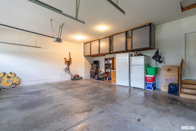 3484 Field Sike Dr, Bettendorf, IA 52722 - garage with freestanding refrigerator and a garage door opener