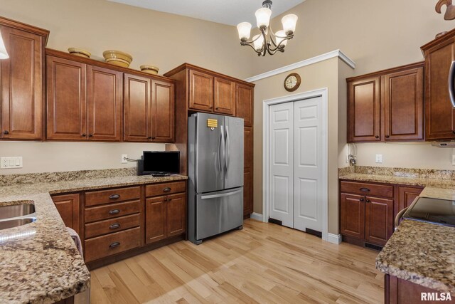 3608 Glengevlin Way, Bettendorf, IA 52722 - kitchen featuring freestanding refrigerator, light wood-style floors, a chandelier, and decorative light fixtures