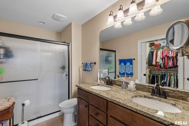 3608 Glengevlin Way, Bettendorf, IA 52722 - full bath featuring a shower stall, double vanity, a walk in closet, toilet, and tile patterned floors