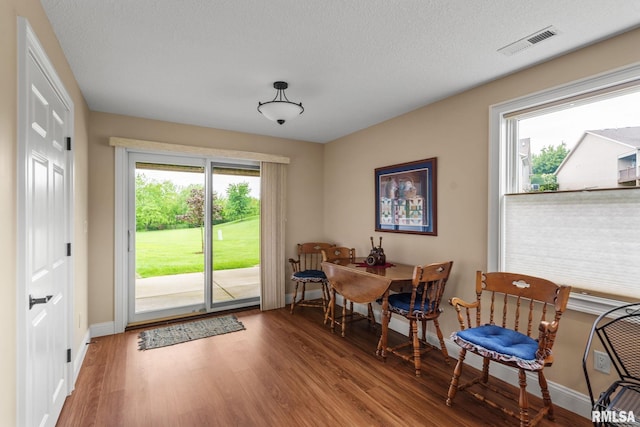 3608 Glengevlin Way, Bettendorf, IA 52722 - dining space featuring baseboards, wood finished floors, and a textured ceiling