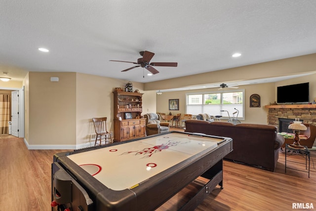 3608 Glengevlin Way, Bettendorf, IA 52722 - rec room with ceiling fan, wood finished floors, a fireplace, recessed lighting, and baseboards