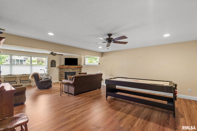 3608 Glengevlin Way, Bettendorf, IA 52722 - bedroom featuring a fireplace, wood finished floors, baseboards, recessed lighting, and a textured ceiling