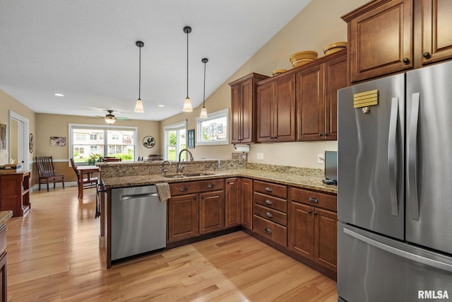 3608 Glengevlin Way, Bettendorf, IA 52722 - kitchen with stainless steel appliances, a sink, a peninsula, a ceiling fan, and light wood finished floors