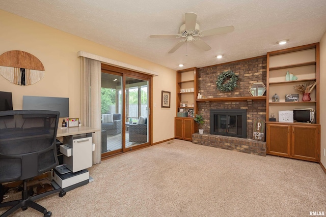 1425 W 48th St, Davenport, IA 52806 - living area featuring carpet floors, a desk, a ceiling fan, a brick fireplace, and a textured ceiling
