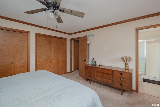 1425 W 48th St, Davenport, IA 52806 - bedroom with light colored carpet, two closets, ensuite bathroom, a ceiling fan, and ornamental molding