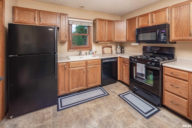 1425 W 48th St, Davenport, IA 52806 - kitchen with black appliances, a sink, light countertops, a textured ceiling, and brown cabinets