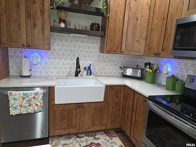 179 Hazel Rd, Simpson, IL 62985 - kitchen featuring appliances with stainless steel finishes, a sink, decorative backsplash, and light countertops