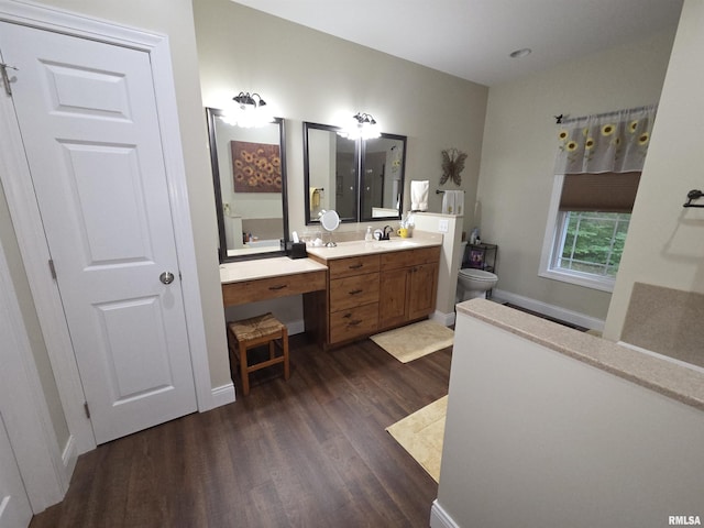 179 Hazel Rd, Simpson, IL 62985 - bathroom featuring wood finished floors, toilet, vanity, and baseboard heating
