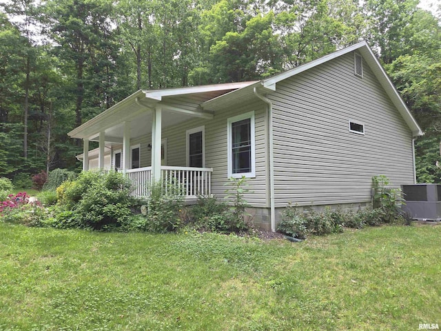 179 Hazel Rd, Simpson, IL 62985 - view of property exterior featuring a porch, a lawn, and cooling unit