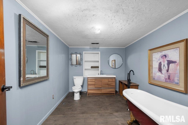 1240 Spruce St, Buffalo, IA 52728 - full bathroom featuring wood finished floors, a freestanding bath, toilet, vanity, and a textured ceiling