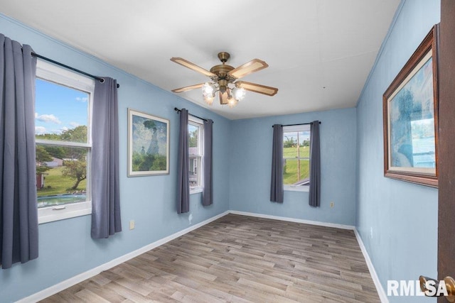 1240 Spruce St, Buffalo, IA 52728 - unfurnished room with wood finished floors, ceiling fan, and baseboards