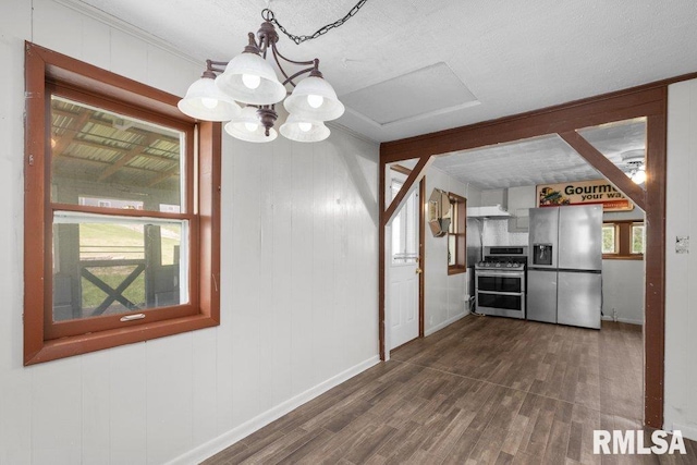 1240 Spruce St, Buffalo, IA 52728 - unfurnished dining area with dark wood finished floors, baseboards, and attic access