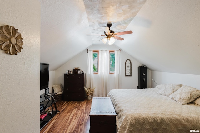 1408 Newton Ave, Johnston City, IL 62951 - bedroom featuring wood finished floors, vaulted ceiling, ceiling fan, and a textured wall