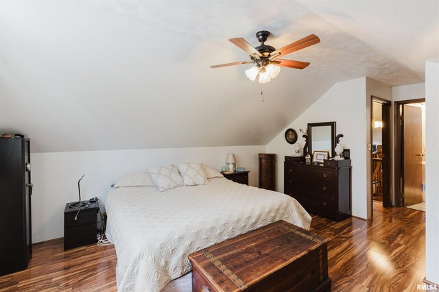 1408 Newton Ave, Johnston City, IL 62951 - bedroom with wood finished floors, vaulted ceiling, freestanding refrigerator, and a ceiling fan