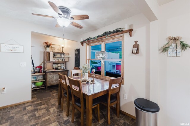 1408 Newton Ave, Johnston City, IL 62951 - dining room featuring baseboards, ceiling fan, and stone finish flooring