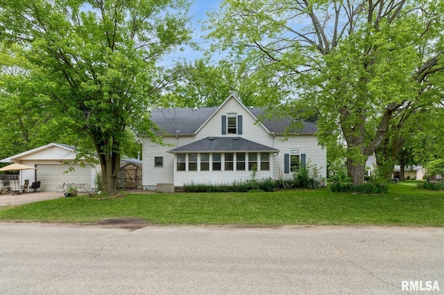 201 4th St, New Boston, IL 61272 - view of front of property featuring a front lawn, a shingled roof, a garage, and driveway