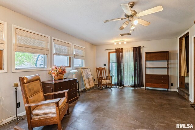 201 4th St, New Boston, IL 61272 - sitting room featuring a ceiling fan and baseboards
