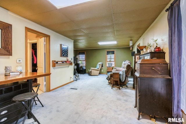 201 4th St, New Boston, IL 61272 - living area featuring carpet flooring, a drop ceiling, and baseboards