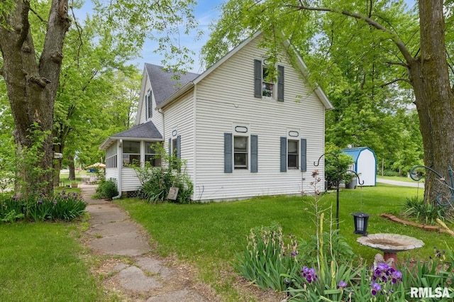 201 4th St, New Boston, IL 61272 - view of home's exterior with a yard and a shingled roof
