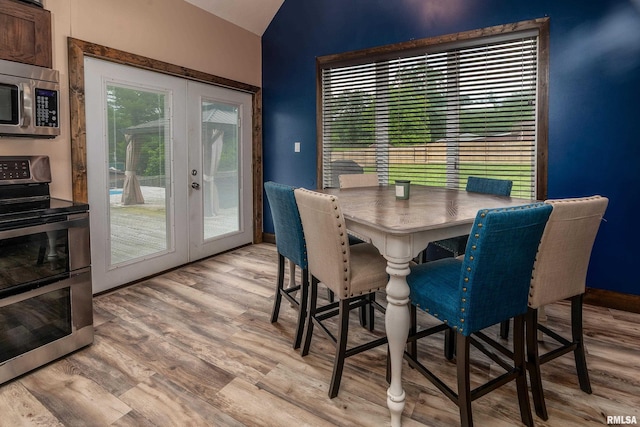 611 E Grand Ave, Carterville, IL 62918 - dining room featuring french doors, lofted ceiling, light wood-style floors, and baseboards