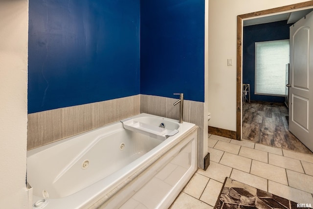 611 E Grand Ave, Carterville, IL 62918 - bathroom with a jetted tub, toilet, and tile patterned flooring