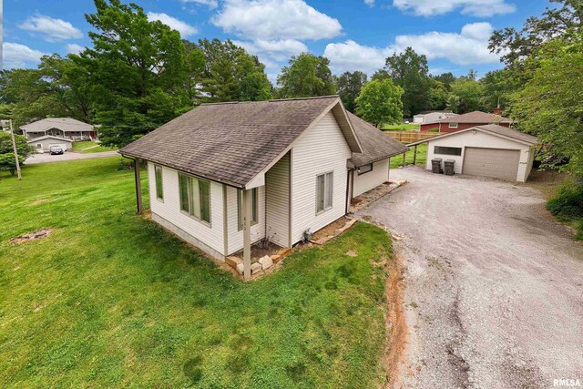 611 E Grand Ave, Carterville, IL 62918 - view of front of property with roof with shingles, an outdoor structure, a garage, and a front yard