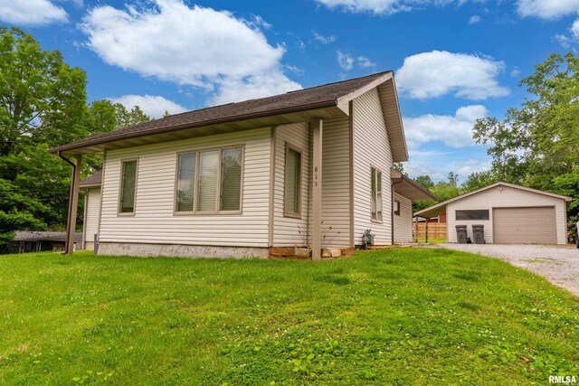 611 E Grand Ave, Carterville, IL 62918 - view of side of property with an outbuilding, a detached garage, and a lawn