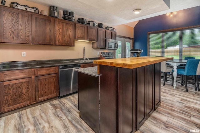 611 E Grand Ave, Carterville, IL 62918 - kitchen with stainless steel appliances, a center island, wood counters, light wood-style flooring, and vaulted ceiling