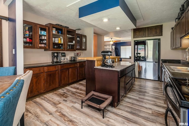 611 E Grand Ave, Carterville, IL 62918 - kitchen featuring smart refrigerator, a textured ceiling, dark brown cabinetry, light wood-style floors, and glass insert cabinets