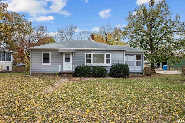 519 2nd St, Camanche, IA 52730 - view of front facade featuring a chimney and a front yard