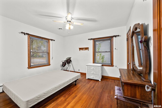 519 2nd St, Camanche, IA 52730 - bedroom with baseboards, wood finished floors, and ceiling fan