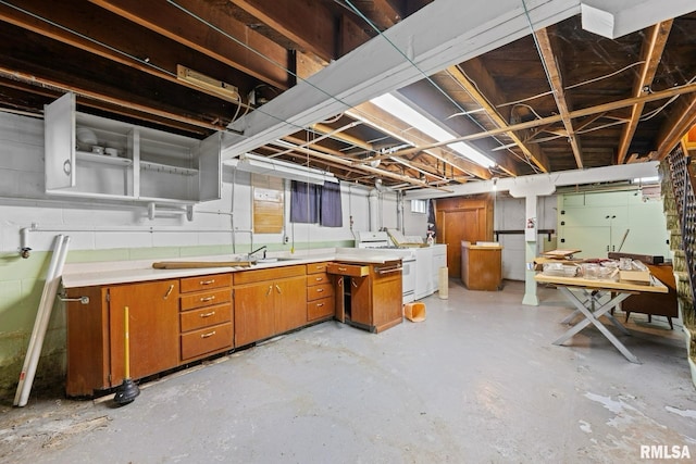 519 2nd St, Camanche, IA 52730 - unfinished basement featuring washer / dryer and a workshop area