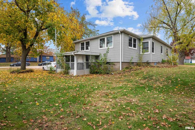 519 2nd St, Camanche, IA 52730 - view of side of home with a sunroom and a yard