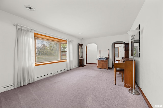 519 2nd St, Camanche, IA 52730 - unfurnished bedroom with arched walkways, carpet flooring, and baseboards