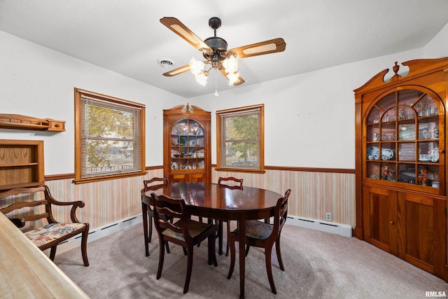 519 2nd St, Camanche, IA 52730 - dining room with a baseboard heating unit, wainscoting, a ceiling fan, and carpet flooring
