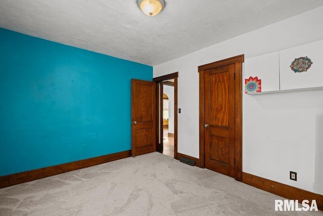 2446 16th Ave, Moline, IL 61265 - unfurnished room with baseboards, carpet, and a textured ceiling