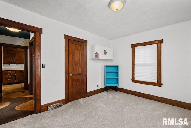 2446 16th Ave, Moline, IL 61265 - unfurnished bedroom featuring baseboards and carpet flooring