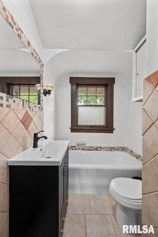 2446 16th Ave, Moline, IL 61265 - bathroom with vanity, a bathtub, toilet, and plenty of natural light