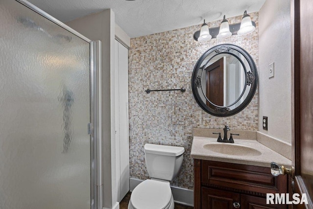 2446 16th Ave, Moline, IL 61265 - bathroom featuring a shower stall, vanity, toilet, and a textured ceiling
