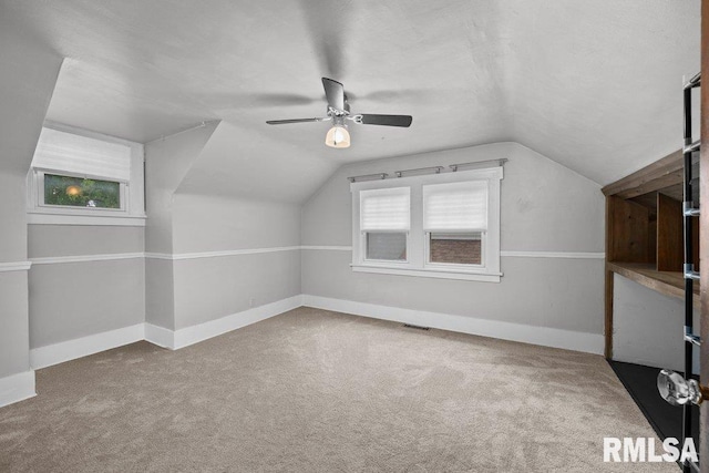 2446 16th Ave, Moline, IL 61265 - additional living space with a ceiling fan, vaulted ceiling, carpet flooring, and baseboards